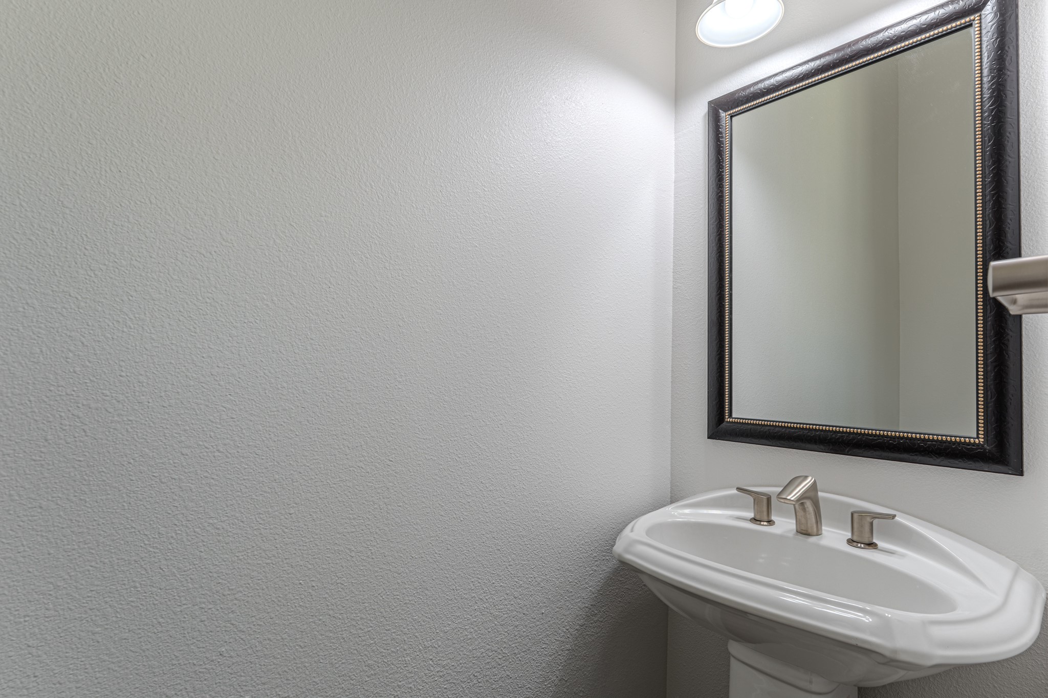 58 Aventura Place Spring, TX 77389 - Photo 45 of 50 a bathroom with a sink and a mirror