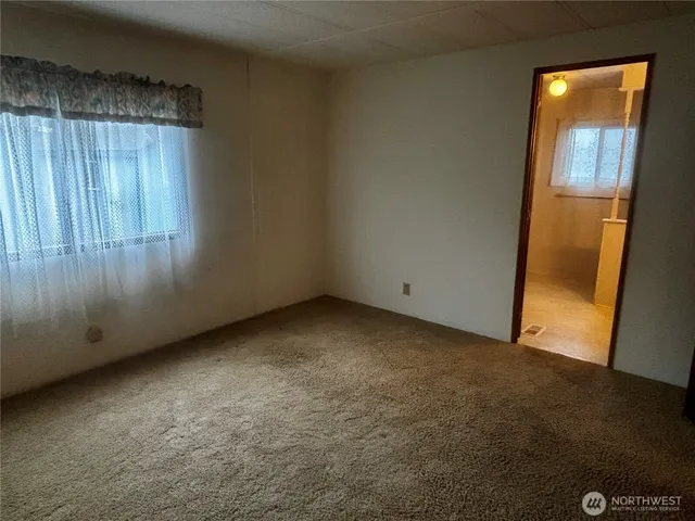a view of an empty room with wooden door