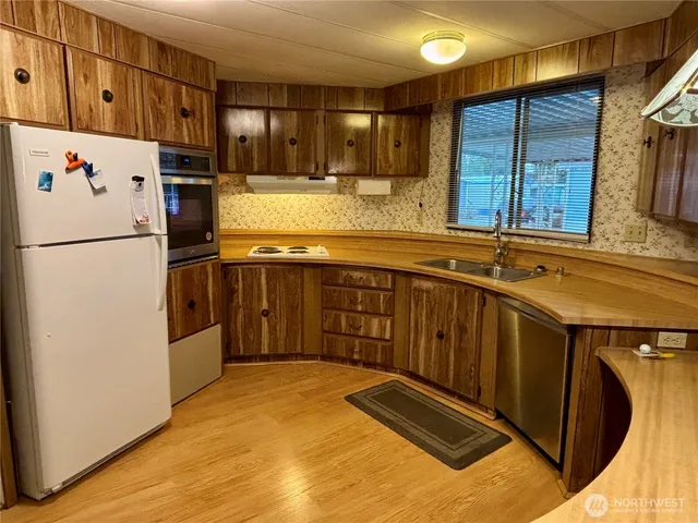 a living room with furniture chandelier and a window