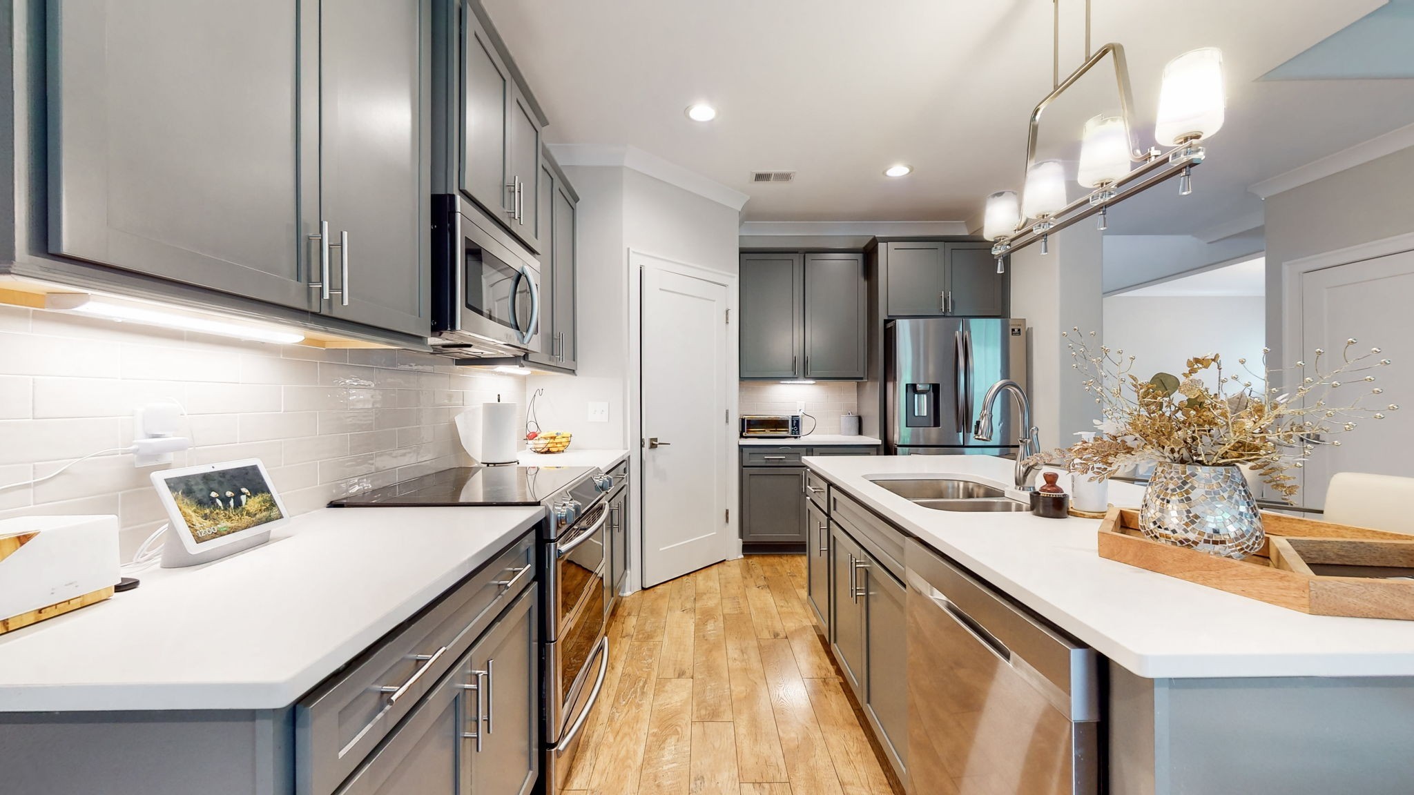 3413 Pershing Drive Murfreesboro, TN 37129 - Photo 12 of 43 a kitchen with a sink stainless steel appliances cabinets and a counter top space