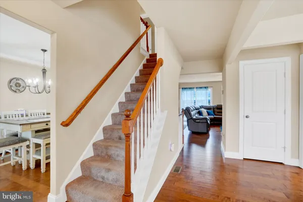 a view of entryway and hall with wooden floor