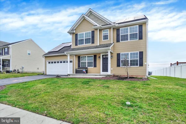 a front view of a house with a yard