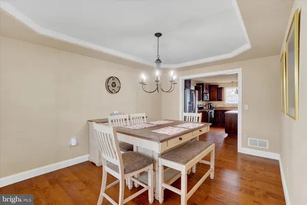 a view of a dining room with furniture and wooden floor