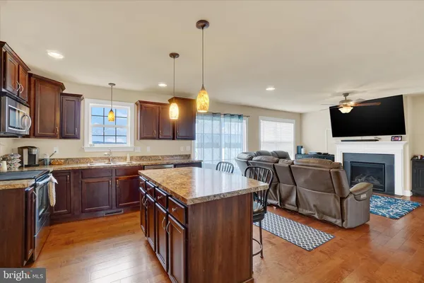 a kitchen with stainless steel appliances granite countertop a stove and a sink