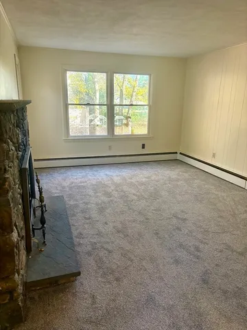 an empty room with furniture and a fireplace