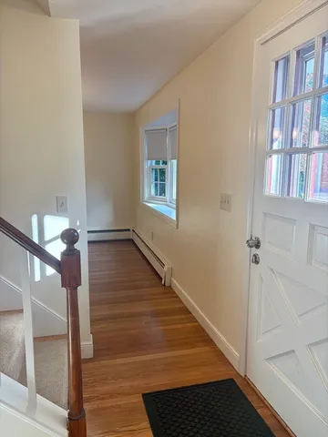 a view of staircase with lots of frames on wall