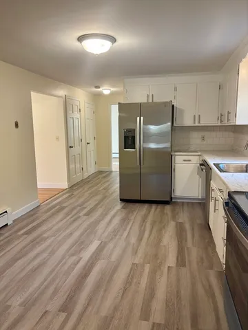 a kitchen with a sink a stove and cabinets