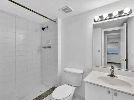 a bedroom with a bed couch and a flat screen tv