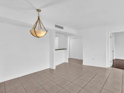 a view of a room with wooden floor and natural light