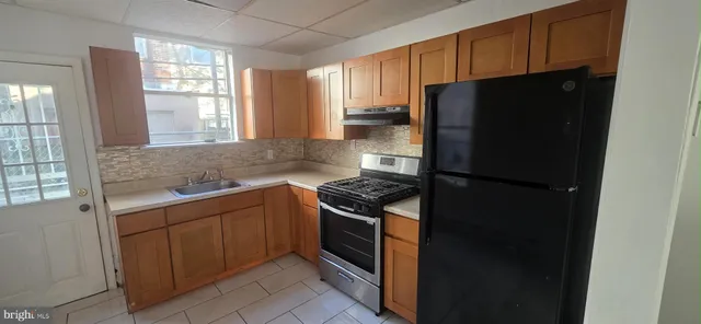 a kitchen with a refrigerator stove and sink
