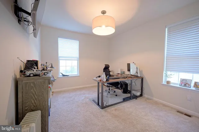 a view of a livingroom with furniture and windows
