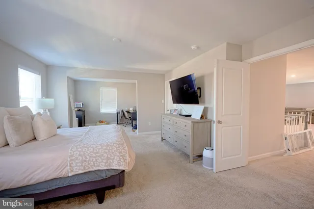 a bedroom with furniture and flat screen tv