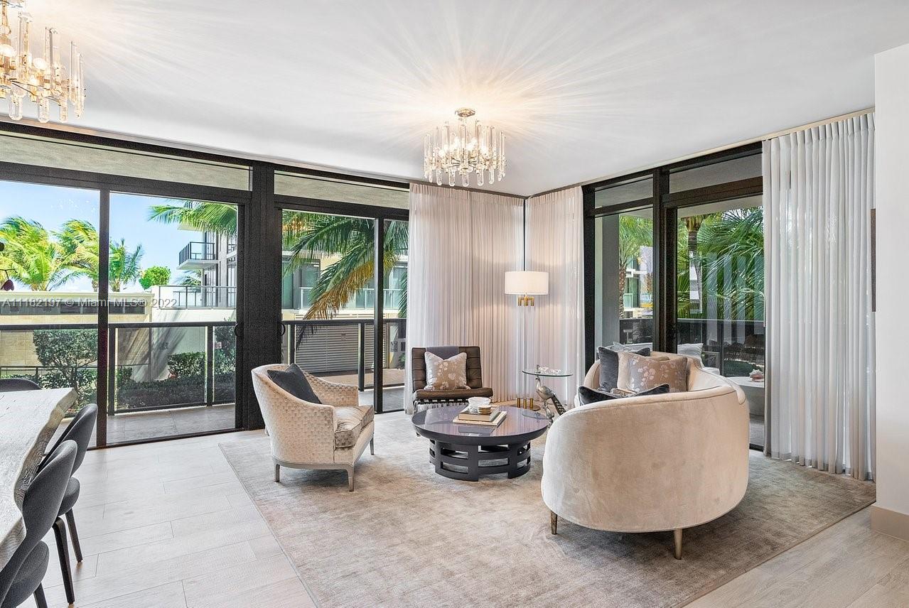 2101 South Surf Road, Unit 2C Hollywood, FL 33019 - Photo 13 of 38 a living room with furniture and a chandelier