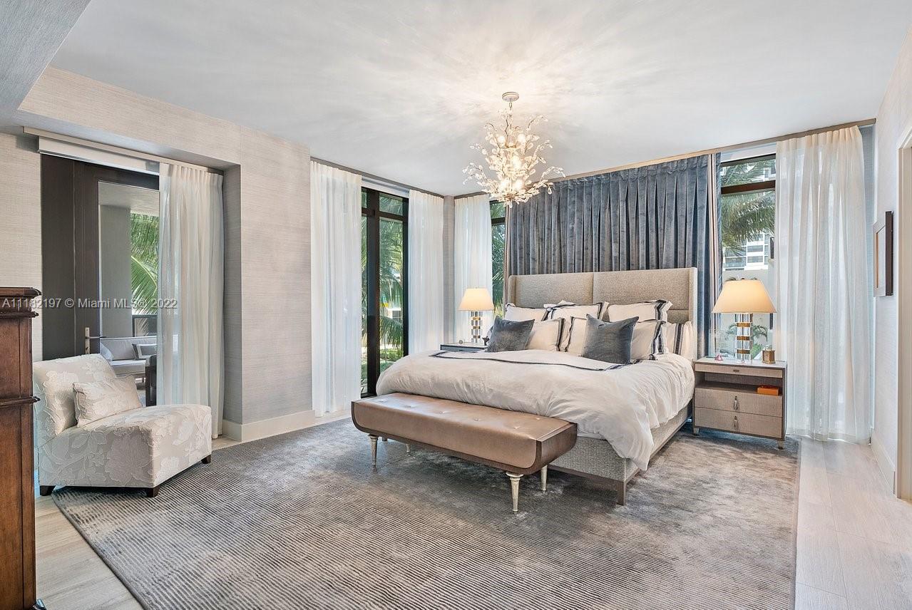 2101 South Surf Road, Unit 2C Hollywood, FL 33019 - Photo 16 of 38 a spacious bedroom with a bed and a chandelier