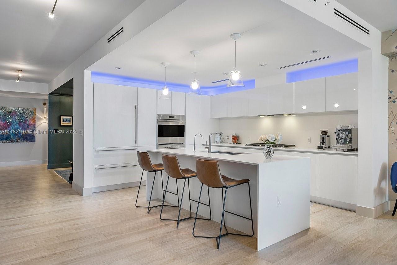 2101 South Surf Road, Unit 2C Hollywood, FL 33019 - Photo 8 of 38 a kitchen with stainless steel appliances kitchen island granite countertop a sink and cabinets