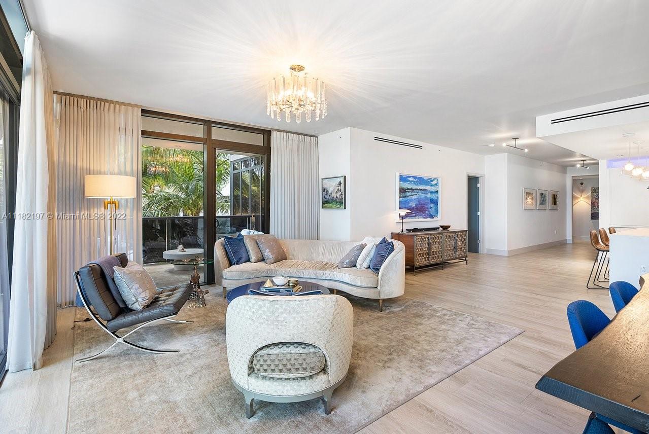 2101 South Surf Road, Unit 2C Hollywood, FL 33019 - Photo 10 of 38 a living room with furniture and a chandelier