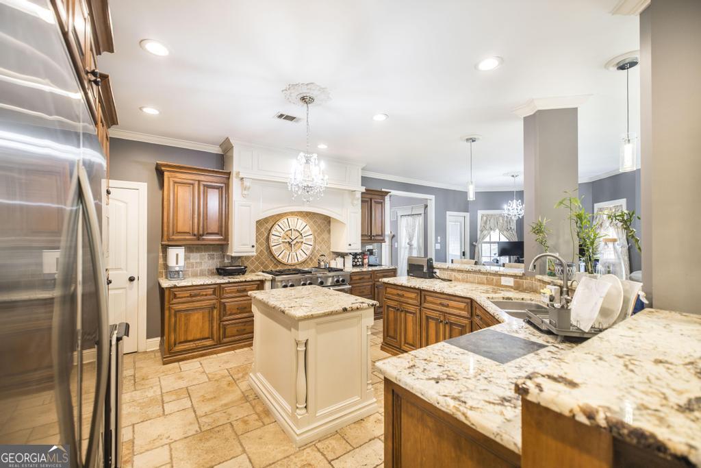 4065 Gordon Road Abbeville, GA 31001 - Photo 17 of 48 a kitchen that has a lot of white cabinets and stainless steel appliances
