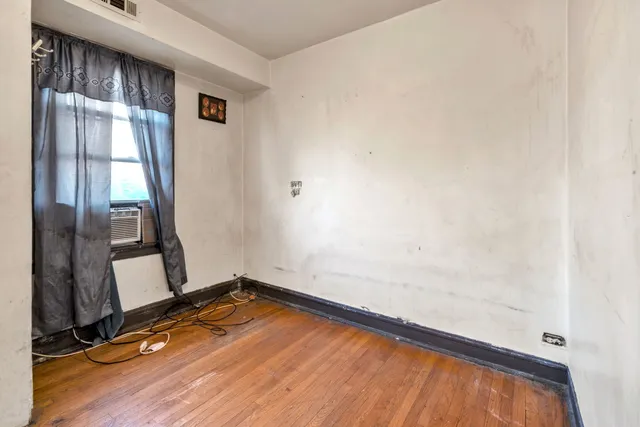 a view of a room with wooden floor and windows