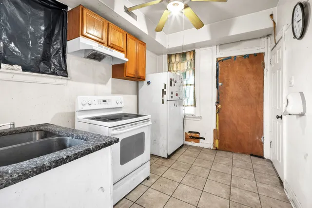 a kitchen with a stove a refrigerator and a sink
