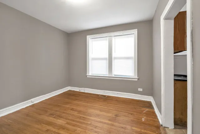 a view of a room with wooden floor and windows