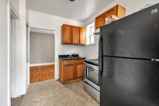a kitchen with stainless steel appliances granite countertop a refrigerator and a sink