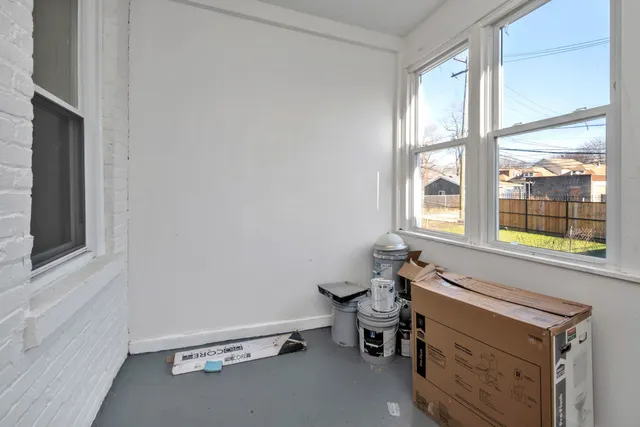 a room with a window and a chair