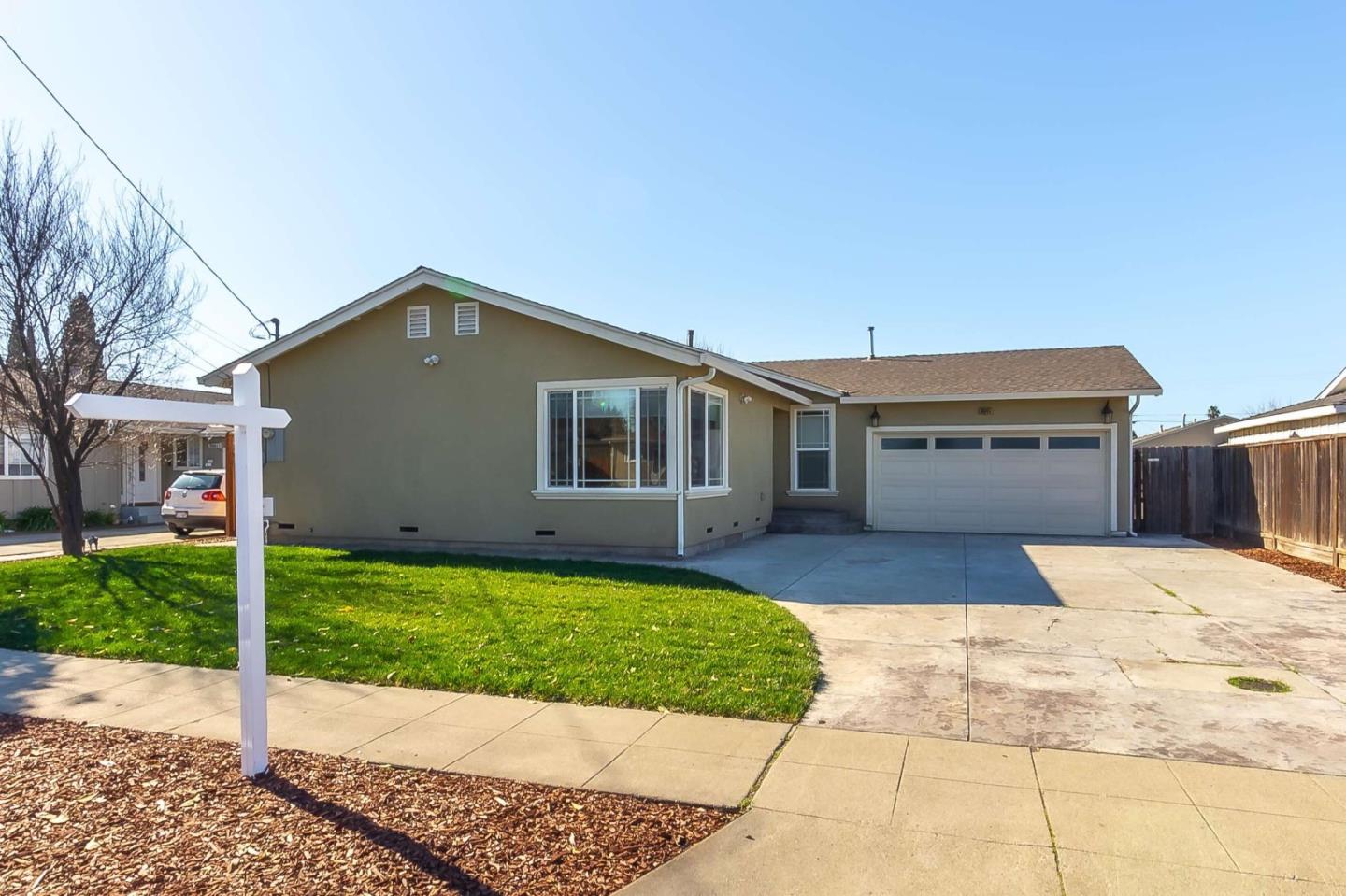 36045 Haley Street Newark, CA 94560 - Photo 2 of 26 a front view of a house with a yard and garage