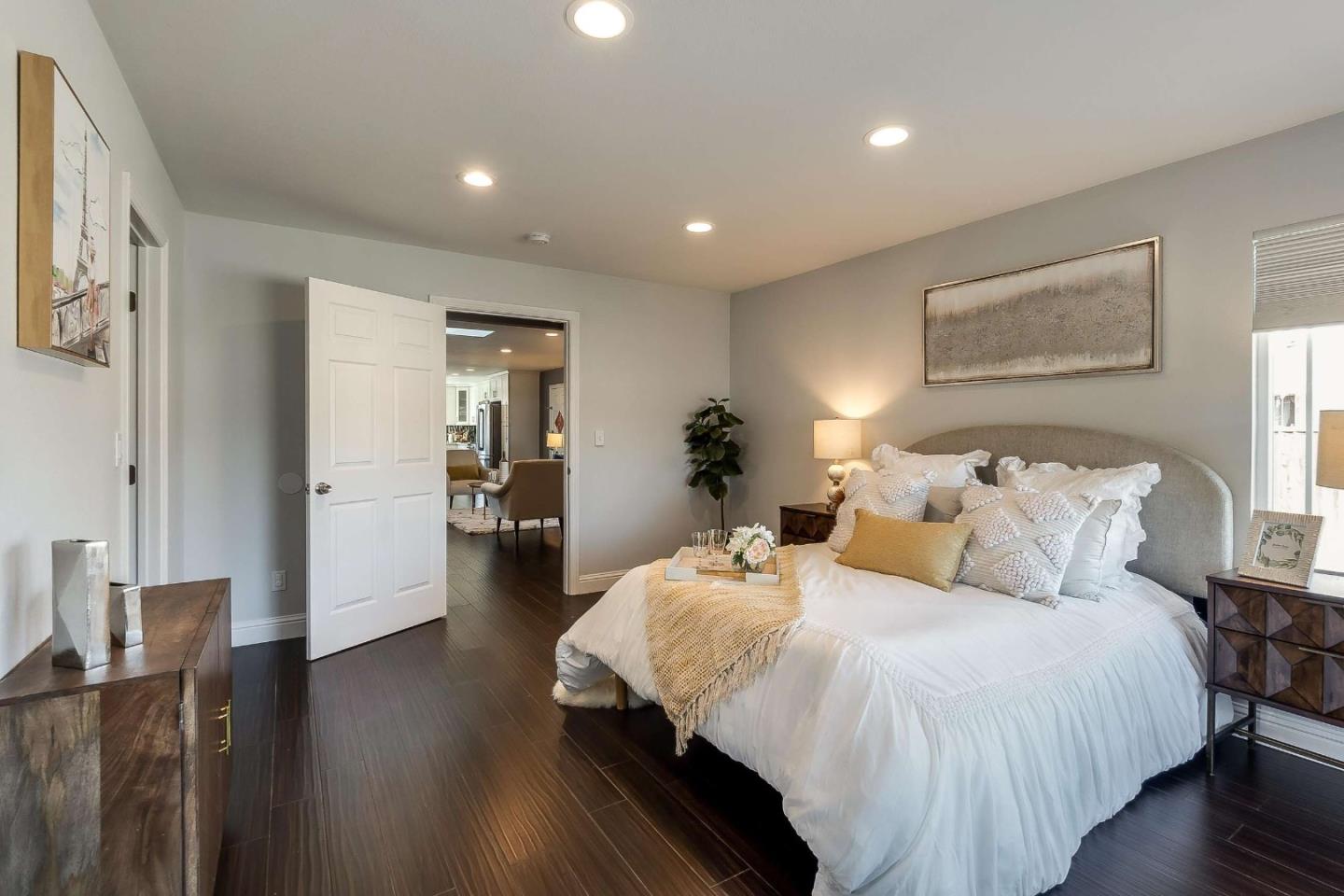 36045 Haley Street Newark, CA 94560 - Photo 16 of 26 a bedroom with bed and a night stand