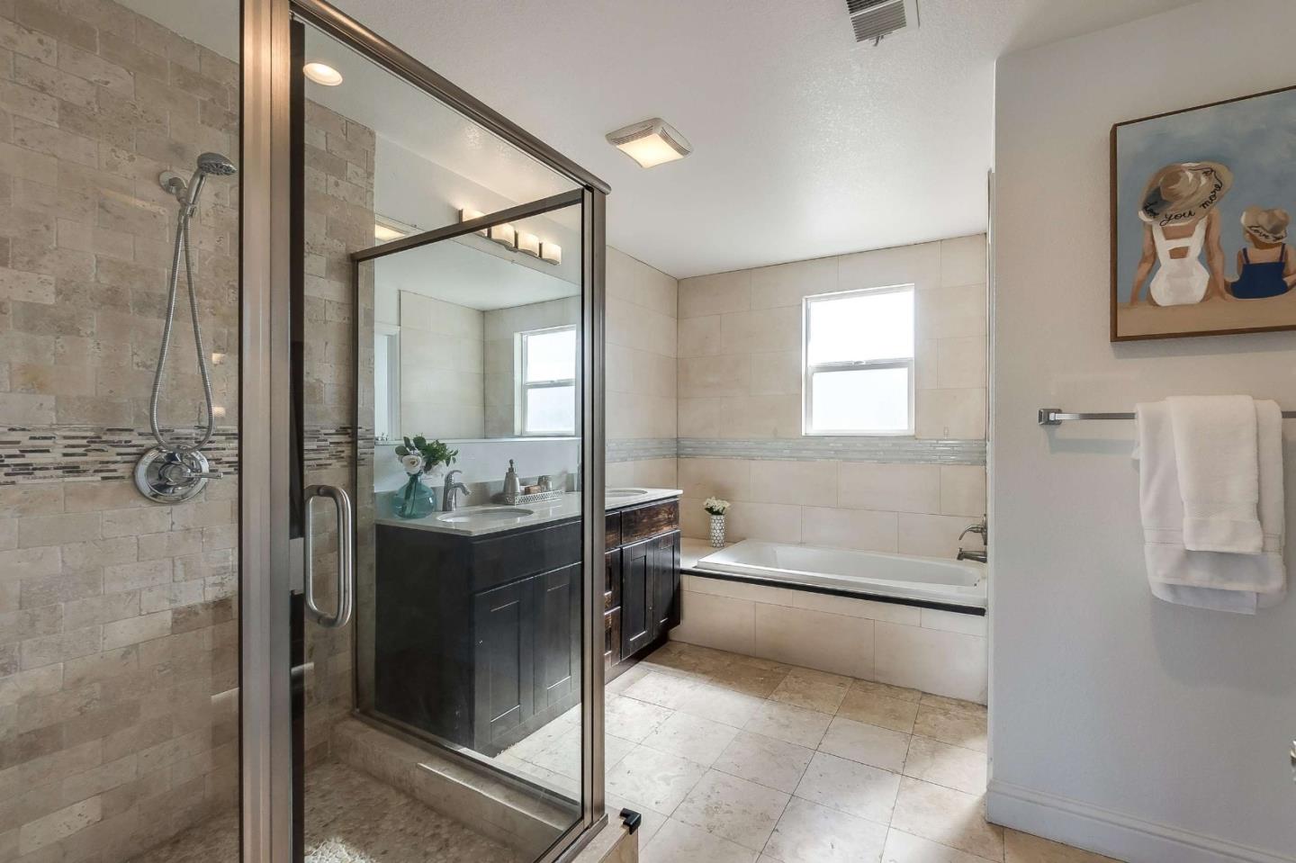36045 Haley Street Newark, CA 94560 - Photo 19 of 26 a bathroom with a tub sink and mirror