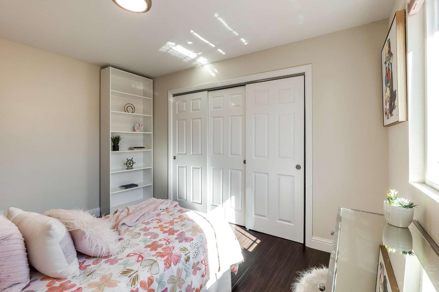 36045 Haley Street Newark, CA 94560 - Photo 22 of 26 a bedroom with a bed and wooden floor