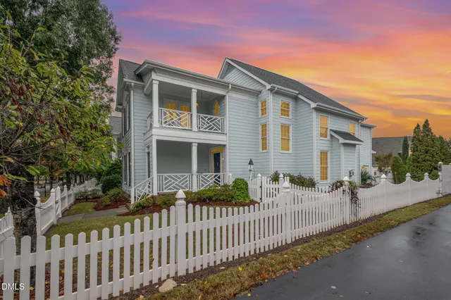 a front view of a house with wooden fence
