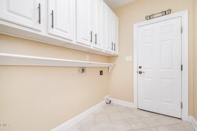 a view of an empty room with an entryway and a window