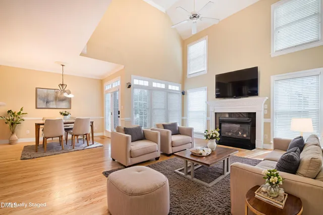 a kitchen with stainless steel appliances granite countertop a sink cabinets and wooden floor