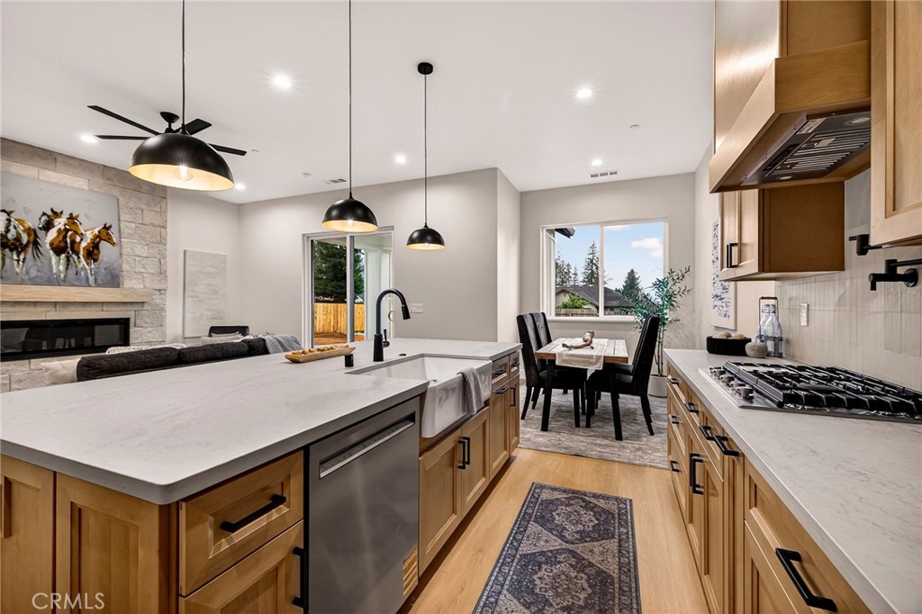 2210 Thornburg Road Paradise, CA 95969 - Photo 25 of 75 a kitchen with stainless steel appliances a stove a chimney a sink and cabinets