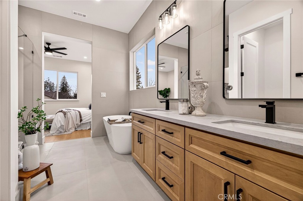 2210 Thornburg Road Paradise, CA 95969 - Photo 33 of 75 a spacious en suite bathroom with a granite countertop sink and a mirror