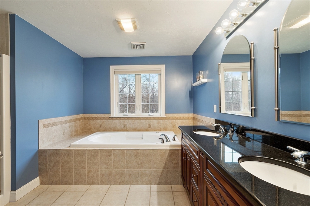 49 Brigham Hill Road Grafton, MA 01519 - Photo 18 of 37 a spacious bathroom with a granite countertop tub sink and mirror