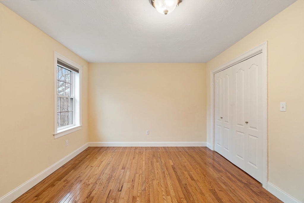 49 Brigham Hill Road Grafton, MA 01519 - Photo 22 of 37 an empty room with wooden floor and windows