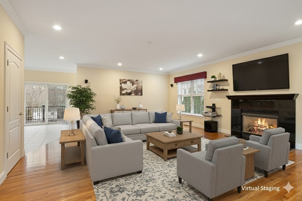 49 Brigham Hill Road Grafton, MA 01519 - Photo 3 of 37 a living room with furniture a fireplace and a flat screen tv