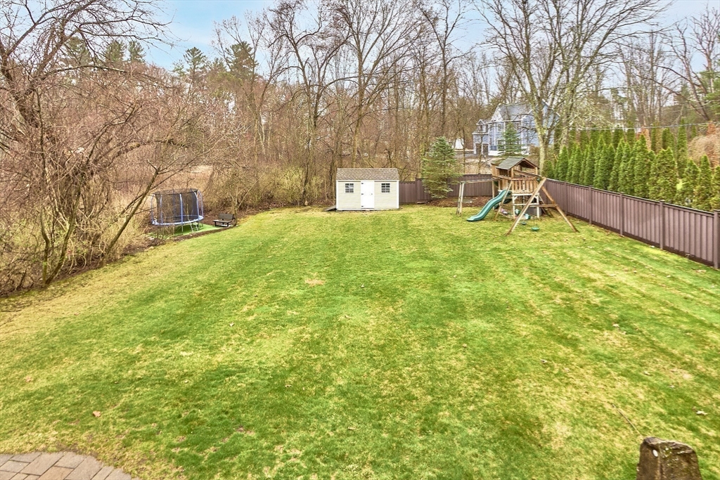 49 Brigham Hill Road Grafton, MA 01519 - Photo 33 of 37 a backyard of a house with table and chairs