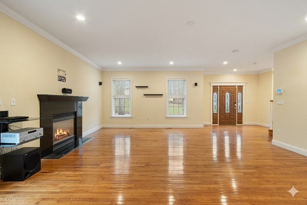 49 Brigham Hill Road Grafton, MA 01519 - Photo 4 of 37 a view of a livingroom with wooden floor and a fireplace