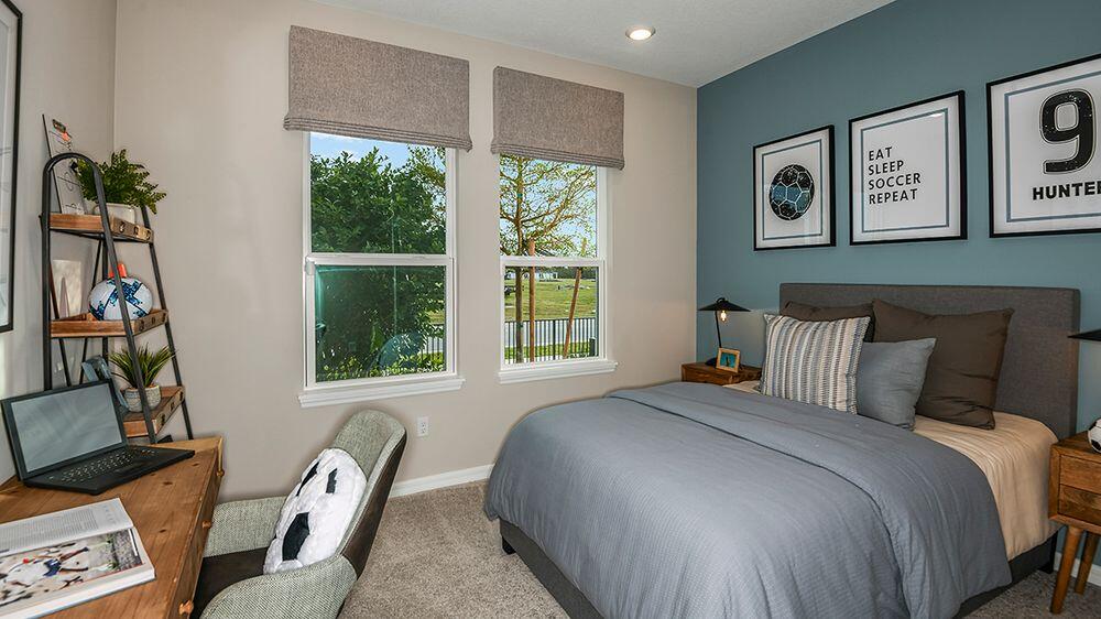604 Southeast Ranch Oak Circle Port St. Lucie, FL 34984 - Photo 23 of 35 a bedroom with a bed and a window