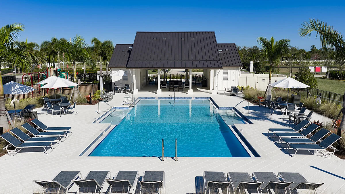 604 Southeast Ranch Oak Circle Port St. Lucie, FL 34984 - Photo 31 of 35 a view of a patio with swimming pool table and chairs