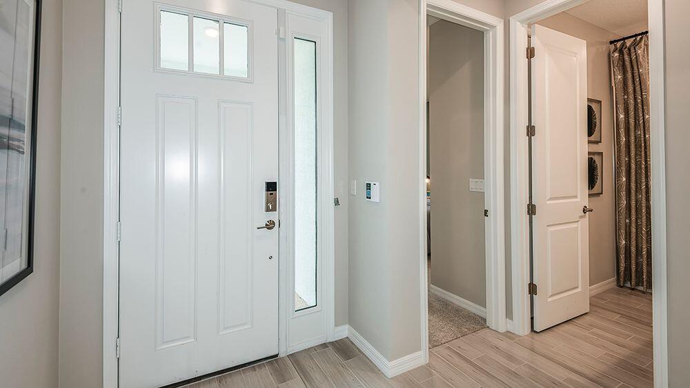 604 Southeast Ranch Oak Circle Port St. Lucie, FL 34984 - Photo 3 of 35 a view of a bathroom from the hallway