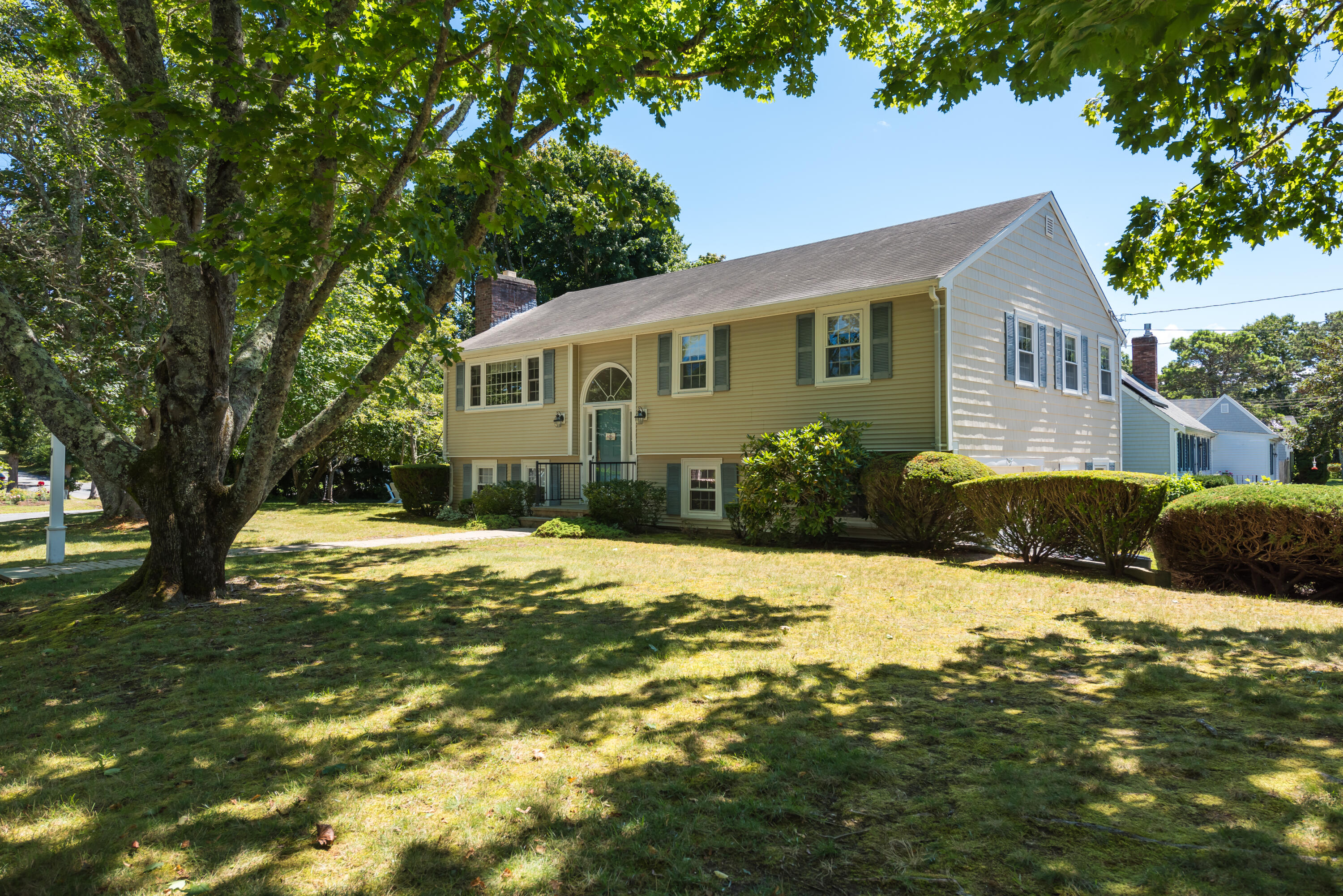60 Cornerwood Drive Harwich, MA 02645 - Photo 1 of 28 a front view of a house with a yard