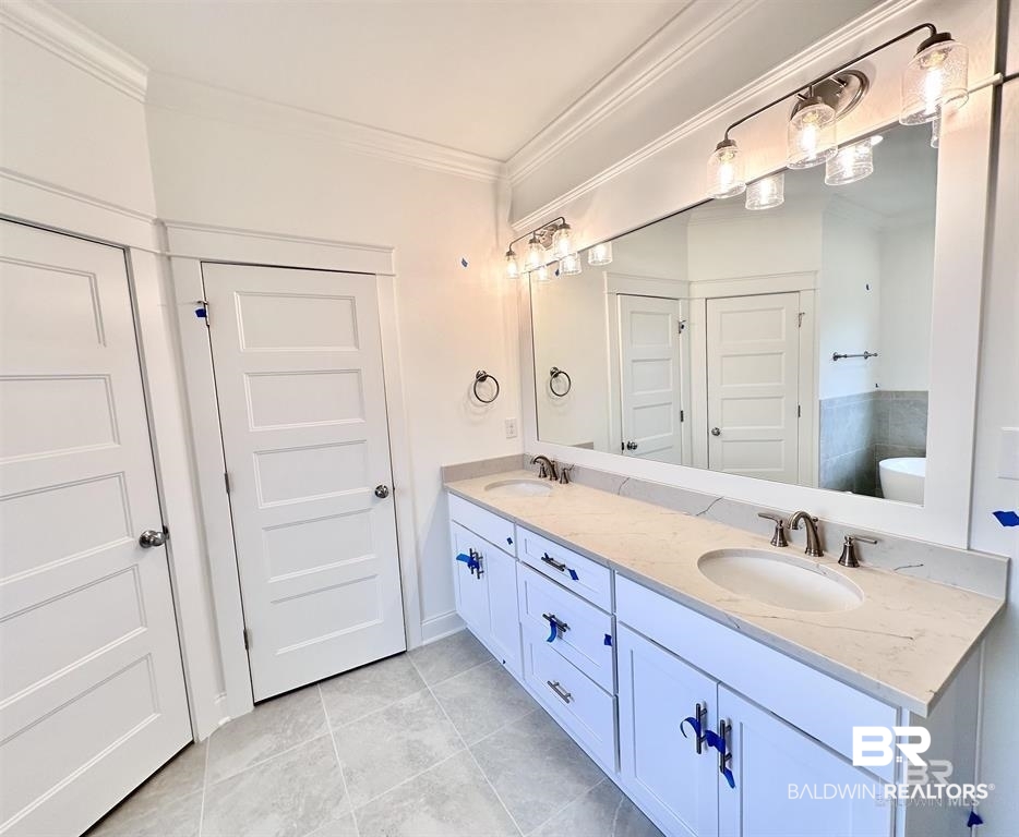 388 Garrison Boulevard Fairhope, AL 36532 - Photo 20 of 34 Bathroom featuring double vanity, tile flooring, and crown molding