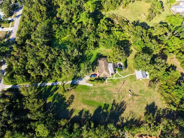 an aerial view of a residential apartment building with a yard