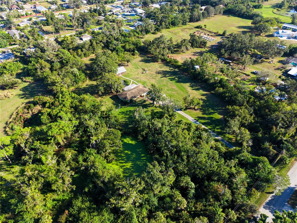4855 Bliss Road Sarasota, FL 34233 - Photo 13 of 15 a view of a lush green forest with lots of trees