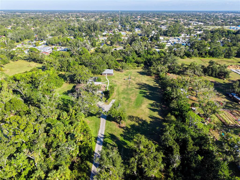 4855 Bliss Road Sarasota, FL 34233 - Photo 6 of 15 an aerial view of residential houses with outdoor space and trees