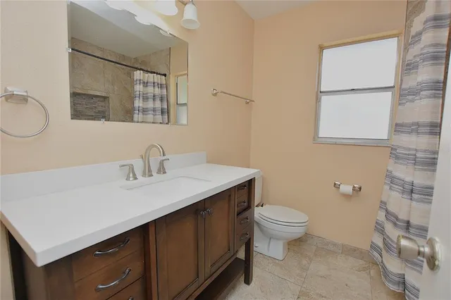 a view of house with a backyard