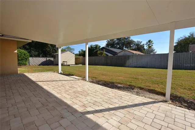 a view of a house with a backyard